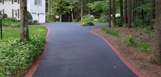 Newly paved asphalt driveway with brick borders
